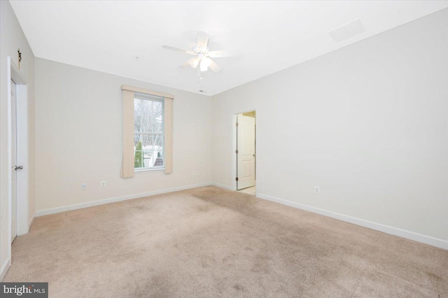 empty room with baseboards and light colored carpet