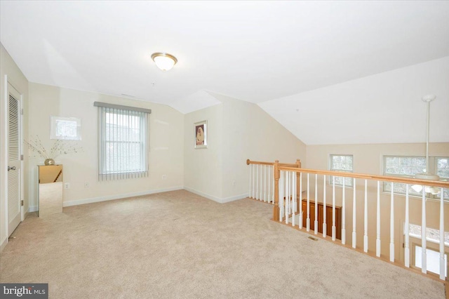 bonus room featuring carpet flooring, baseboards, and vaulted ceiling