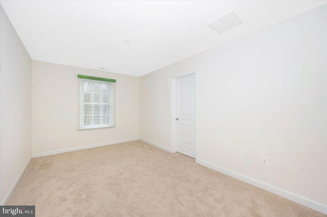 spare room featuring baseboards and carpet flooring