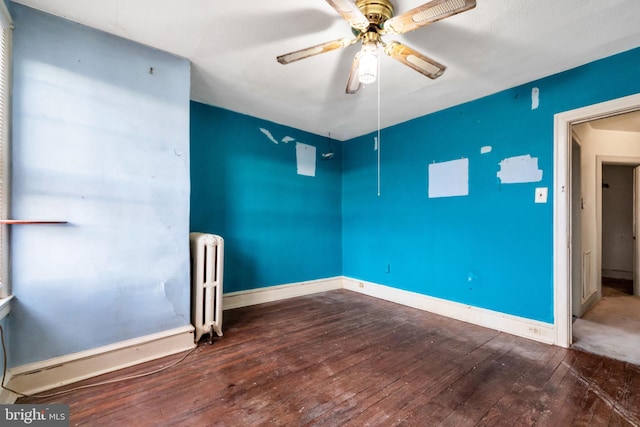 unfurnished room with hardwood / wood-style flooring, baseboards, radiator, and ceiling fan