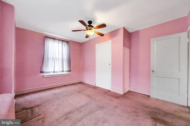 unfurnished bedroom with baseboards, a ceiling fan, and carpet floors