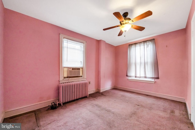 empty room featuring carpet floors, radiator heating unit, cooling unit, and baseboards