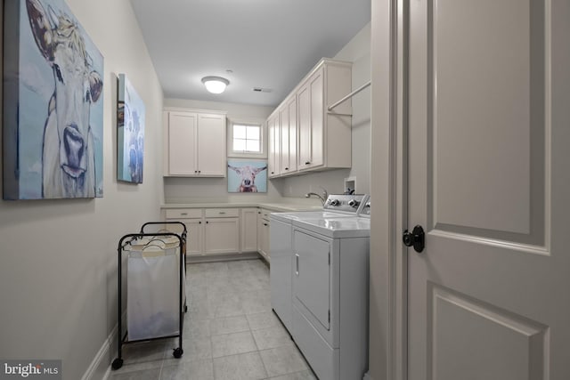 laundry room with cabinet space, washing machine and clothes dryer, light tile patterned floors, visible vents, and baseboards