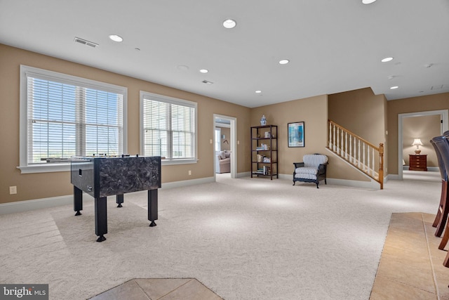 playroom featuring visible vents, baseboards, light colored carpet, and a healthy amount of sunlight