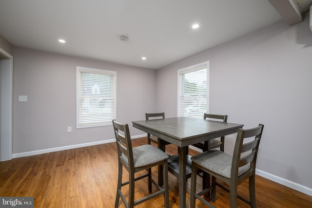 dining space featuring recessed lighting, baseboards, and wood finished floors