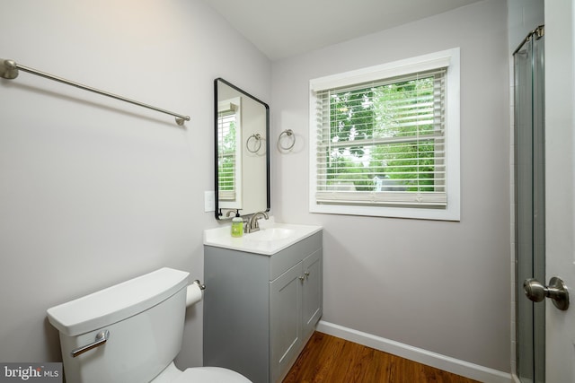 full bathroom with vanity, toilet, wood finished floors, and baseboards