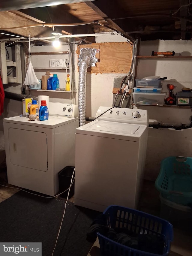 clothes washing area with washer and clothes dryer and laundry area