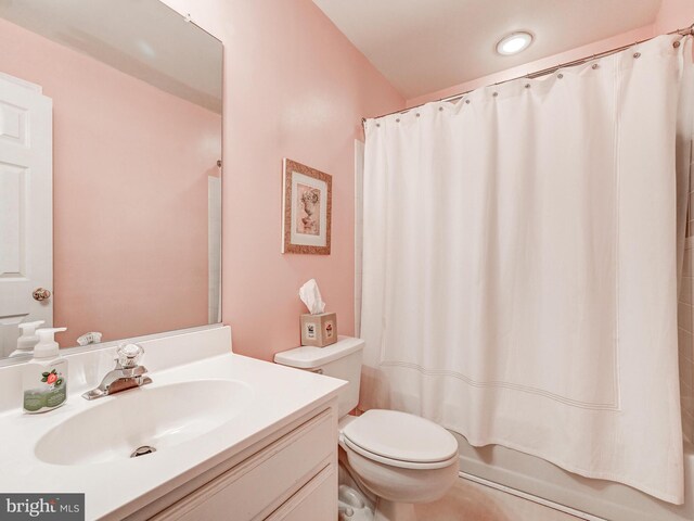 full bathroom featuring toilet, shower / bathtub combination with curtain, and vanity