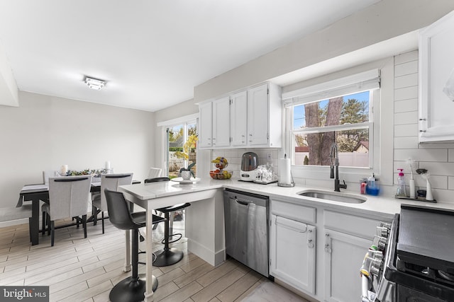 11 New Coach Pl, Willingboro, NJ 08046 - kitchen featuring stainless steel appliances, tasteful backsplash, a sink, light countertops, and white cabinets