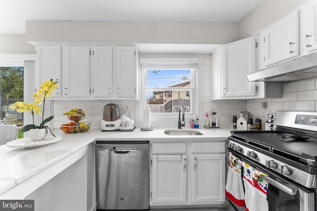 11 New Coach Pl, Willingboro, NJ 08046 - kitchen featuring appliances with stainless steel finishes, under cabinet range hood, white cabinetry, a sink, and tasteful backsplash