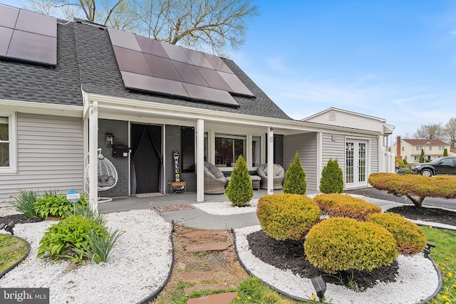 11 New Coach Pl, Willingboro, NJ 08046 - property entrance featuring a shingled roof, roof mounted solar panels, covered porch, and french doors