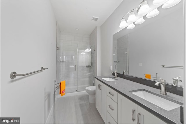full bathroom with toilet, visible vents, a sink, and a stall shower
