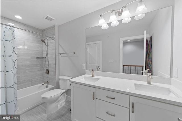 full bathroom with double vanity, visible vents, toilet, and a sink