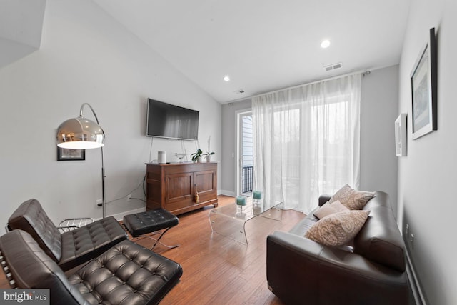 living area featuring vaulted ceiling, baseboards, visible vents, recessed lighting, and wood finished floors