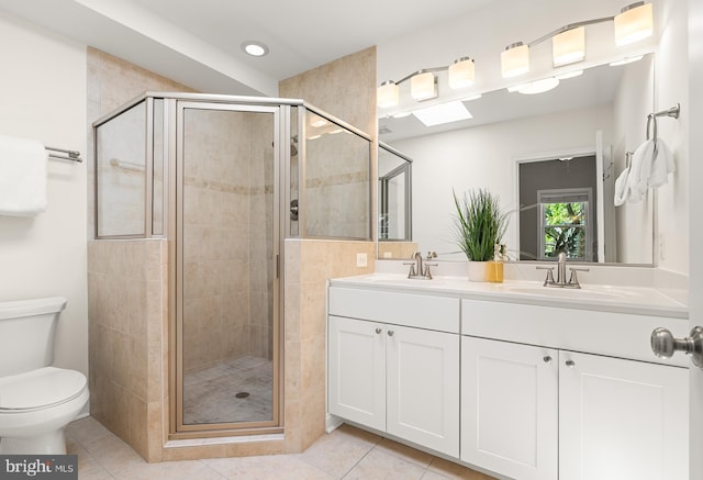 bathroom featuring tile patterned flooring, a sink, and a stall shower