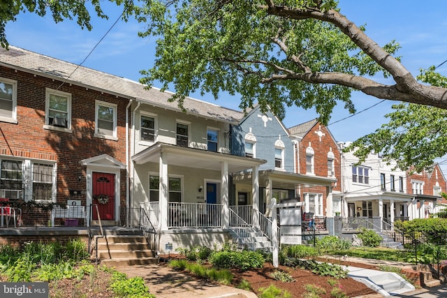 multi unit property with covered porch and brick siding