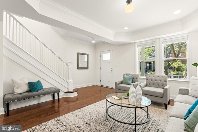 living area with crown molding, baseboards, stairway, and wood finished floors