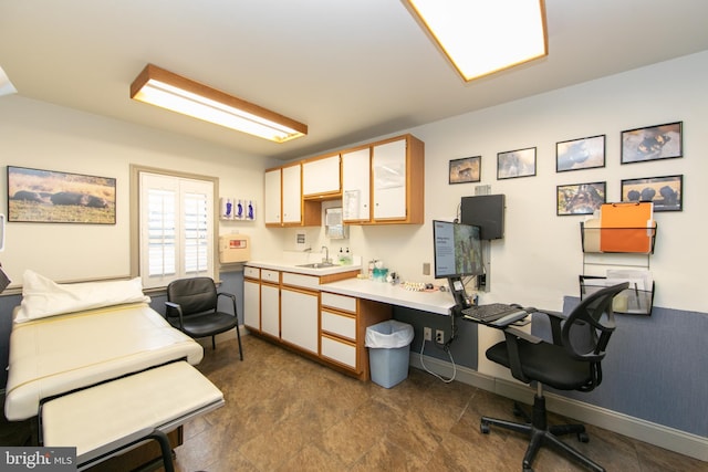 office with baseboards and a sink