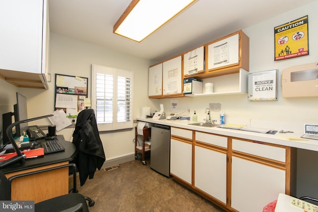 kitchen featuring a sink, dishwasher, light countertops, white cabinetry, and visible vents