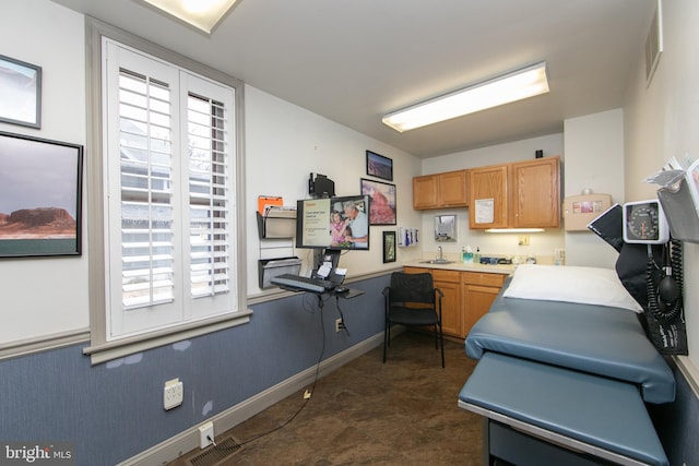 kitchen featuring a wealth of natural light, a sink, visible vents, and light countertops