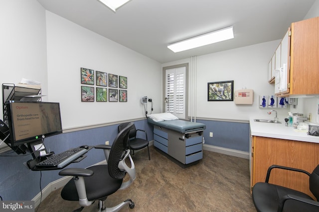 office with baseboards and a sink