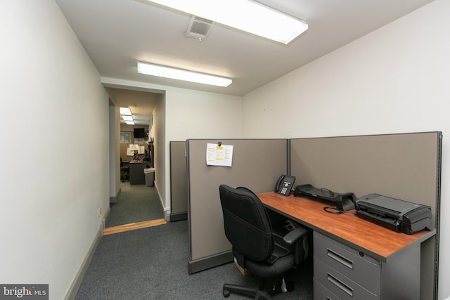 home office featuring dark carpet, visible vents, and baseboards