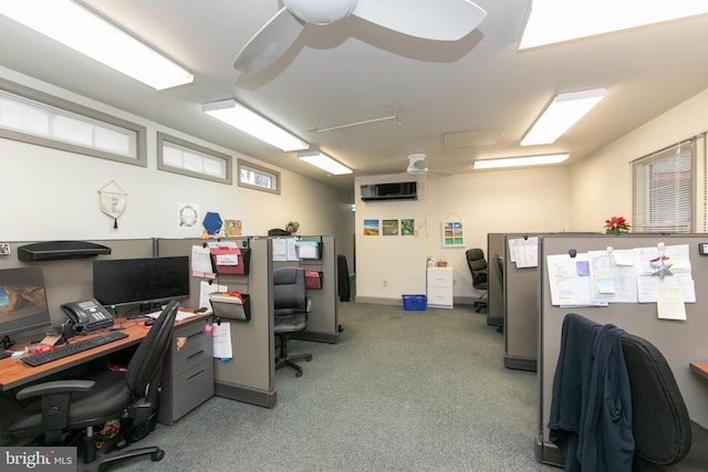 office space with an AC wall unit, carpet floors, and ceiling fan