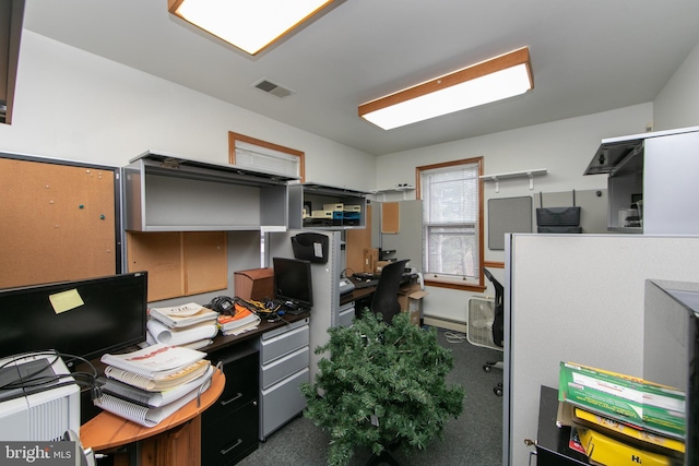 home office featuring a baseboard heating unit and visible vents