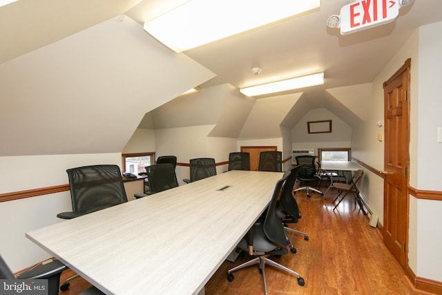 office with vaulted ceiling and wood finished floors
