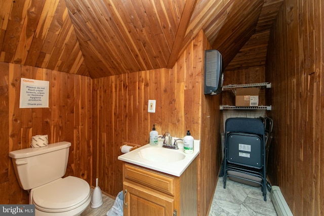 bathroom with lofted ceiling, wooden walls, vanity, and toilet