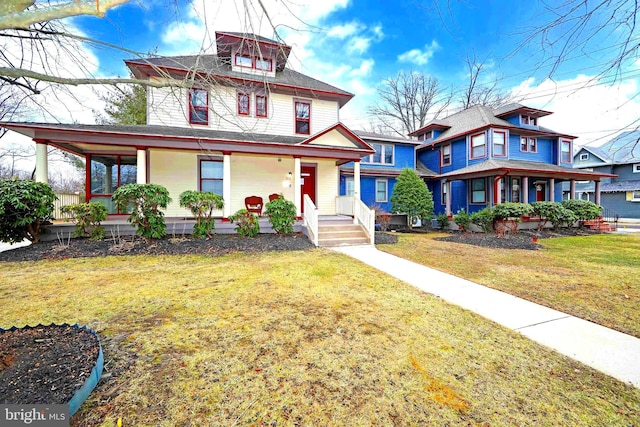 view of front of home with a porch and a front yard