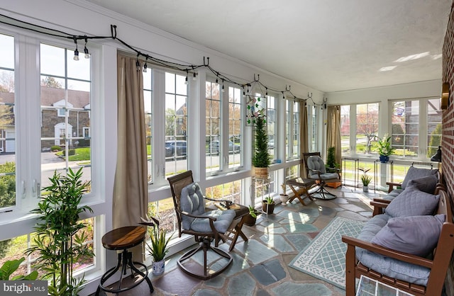 538 Gainsboro Rd, Drexel Hill, PA 19026 - sunroom / solarium featuring stone finish floor, ornamental molding, and a wealth of natural light