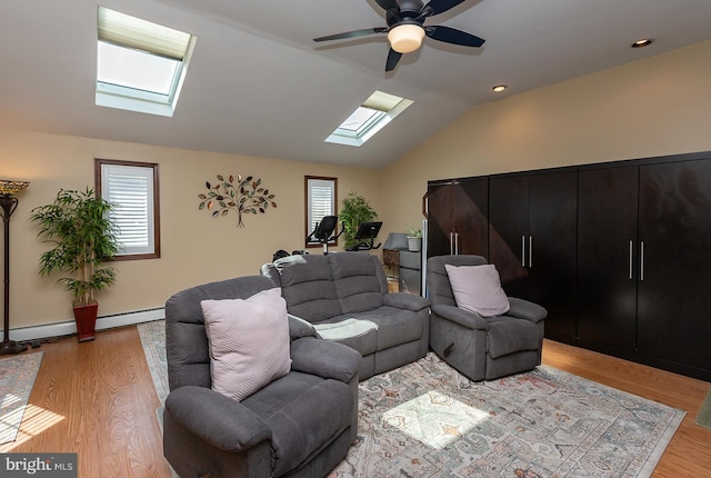 538 Gainsboro Rd, Drexel Hill, PA 19026 - living room with vaulted ceiling with skylight, a baseboard radiator, a ceiling fan, and light wood-style floors
