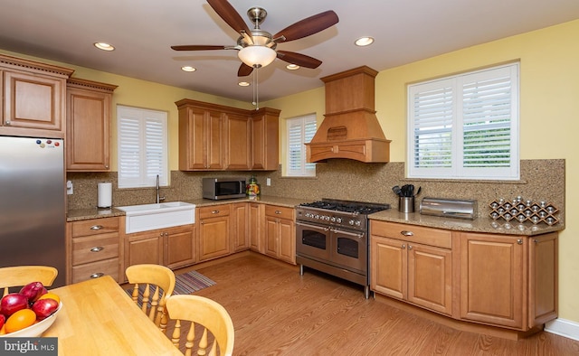 538 Gainsboro Rd, Drexel Hill, PA 19026 - kitchen with custom exhaust hood, light wood-type flooring, a ceiling fan, stainless steel appliances, and a sink