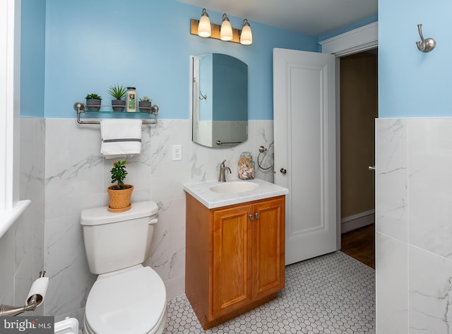 538 Gainsboro Rd, Drexel Hill, PA 19026 - bathroom with toilet, vanity, a wainscoted wall, and tile walls