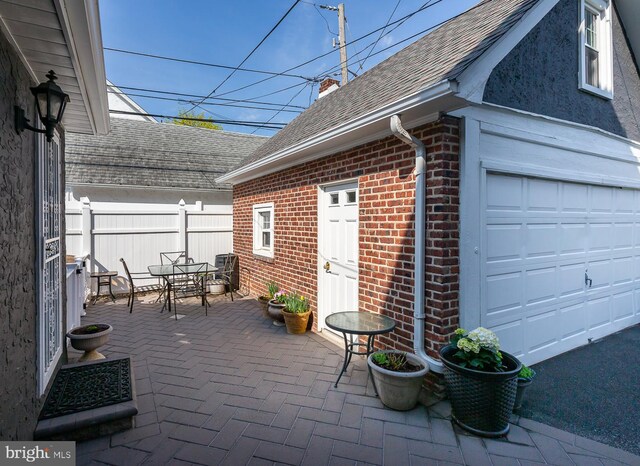 538 Gainsboro Rd, Drexel Hill, PA 19026 - view of patio / terrace with outdoor dining space, a garage, and fence