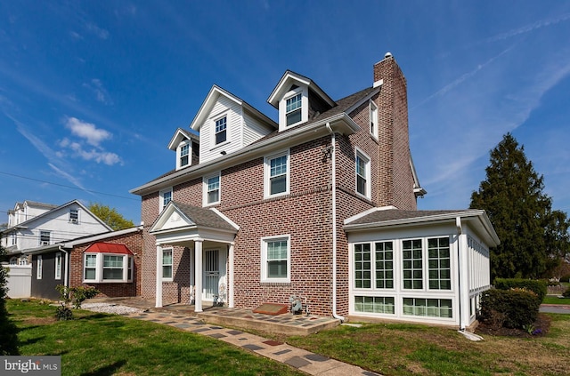 538 Gainsboro Rd, Drexel Hill, PA 19026 - view of front of property featuring a front yard, brick siding, and a chimney