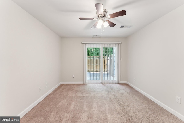 empty room featuring baseboards, a ceiling fan, carpet flooring, and visible vents