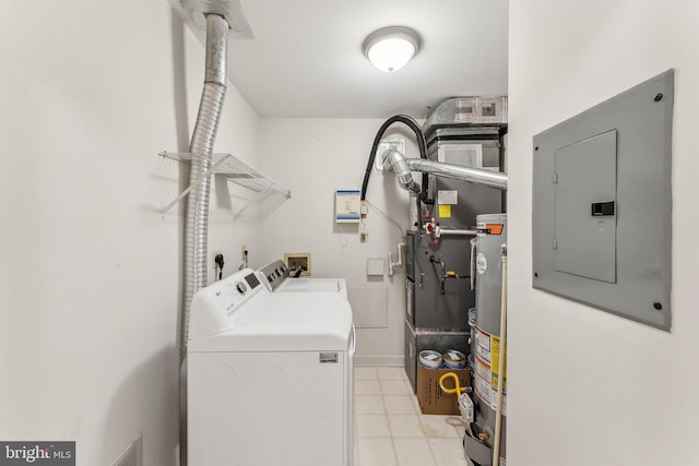 clothes washing area with electric panel, laundry area, light tile patterned floors, water heater, and washer and dryer