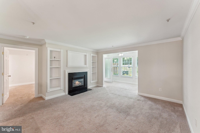unfurnished living room featuring baseboards, ornamental molding, and carpet