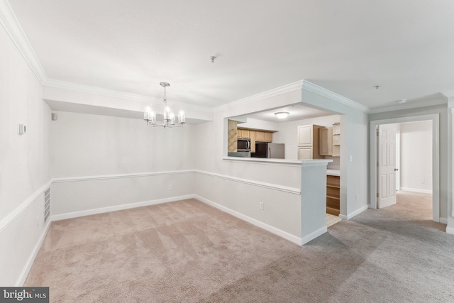 empty room with an inviting chandelier, baseboards, crown molding, and light carpet