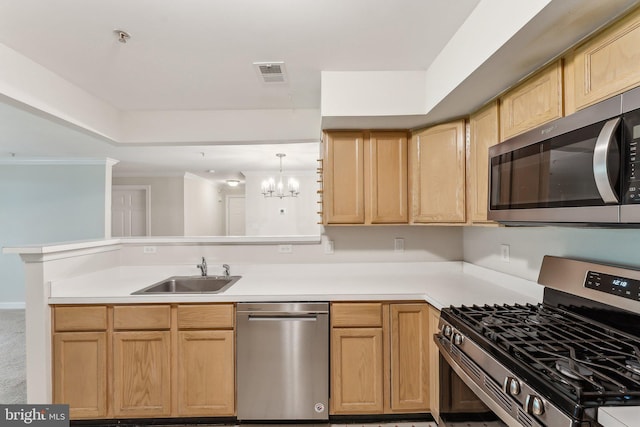 kitchen with a sink, light brown cabinets, stainless steel appliances, a peninsula, and visible vents