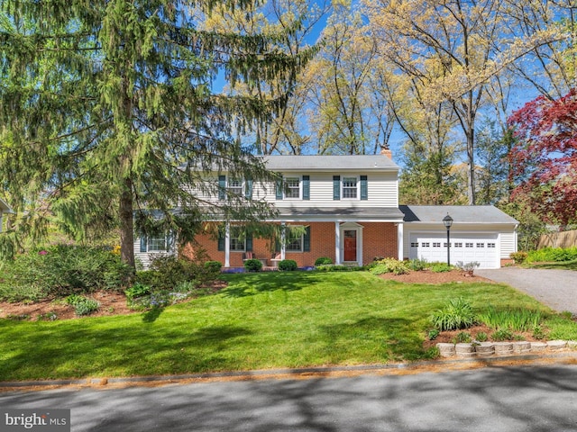 506 Devonshire Ln, Severna Park, MD 21146 - view of front of property featuring an attached garage, asphalt driveway, a chimney, brick siding, and a front yard