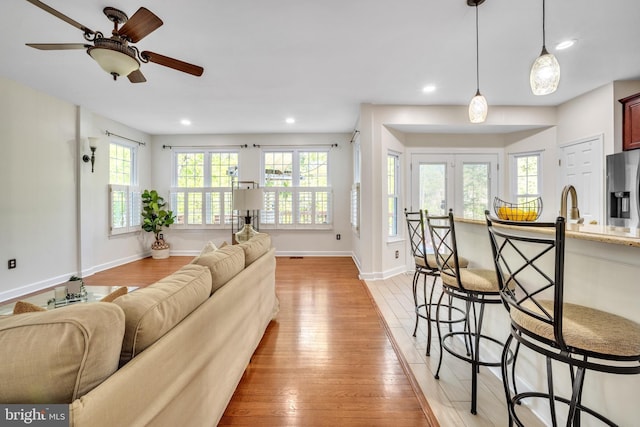8785 Partridge Run Way, Bristow, VA 20136 - living room with light wood-style floors, recessed lighting, baseboards, and a ceiling fan