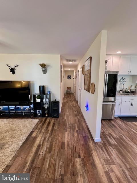 corridor featuring dark wood finished floors