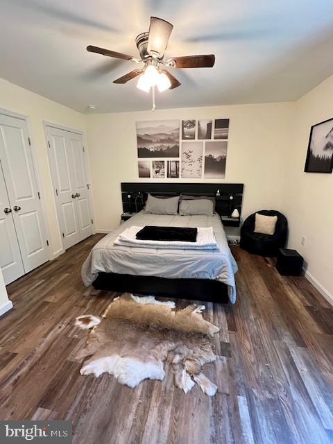 bedroom featuring wood finished floors, baseboards, and a ceiling fan