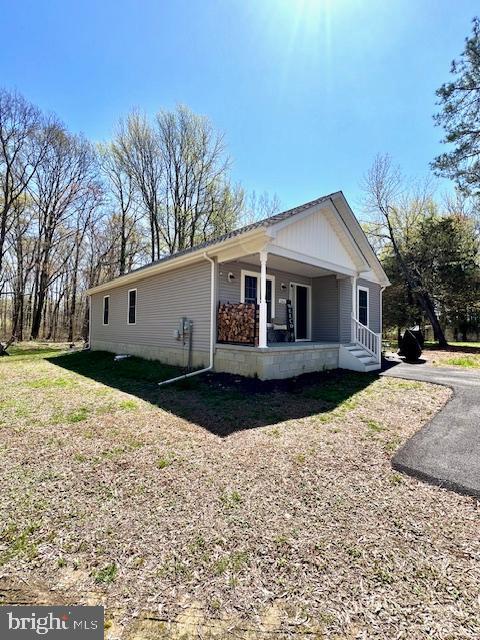 view of side of property with covered porch