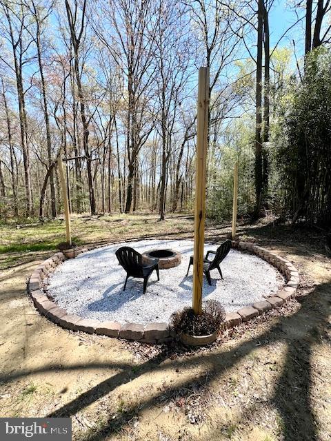 view of home's community with a fire pit