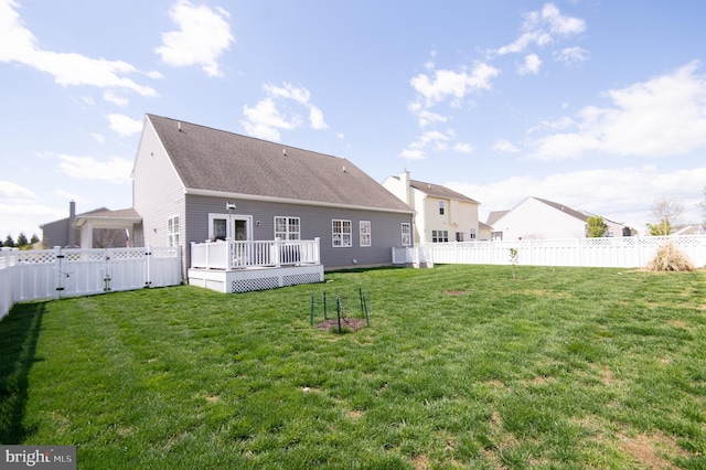 304 Regulator Dr S, Cambridge, MD 21613 - rear view of house featuring a fenced backyard, a wooden deck, a shingled roof, and a lawn