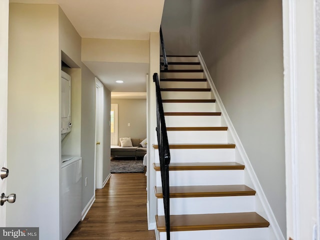 staircase featuring recessed lighting, baseboards, stacked washer and dryer, and wood finished floors